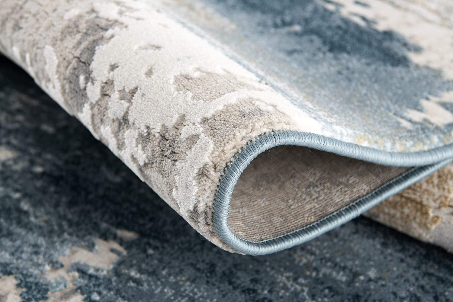 7' X 10' Cream And Blue Abstract Patches Area Rug